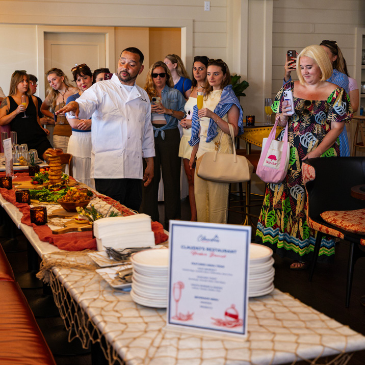 Tide and Table catered gathering with guests around a generous table